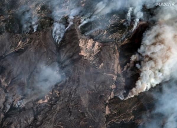 Aerial view of brown earth and smoke.